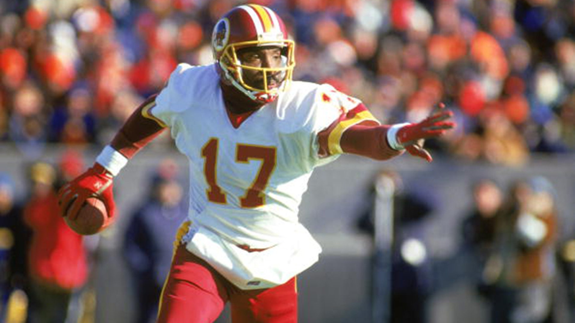 1987: Doug Williams #17 of the Washington Redskins scrambles with the ball during a 1987 NFL season game.