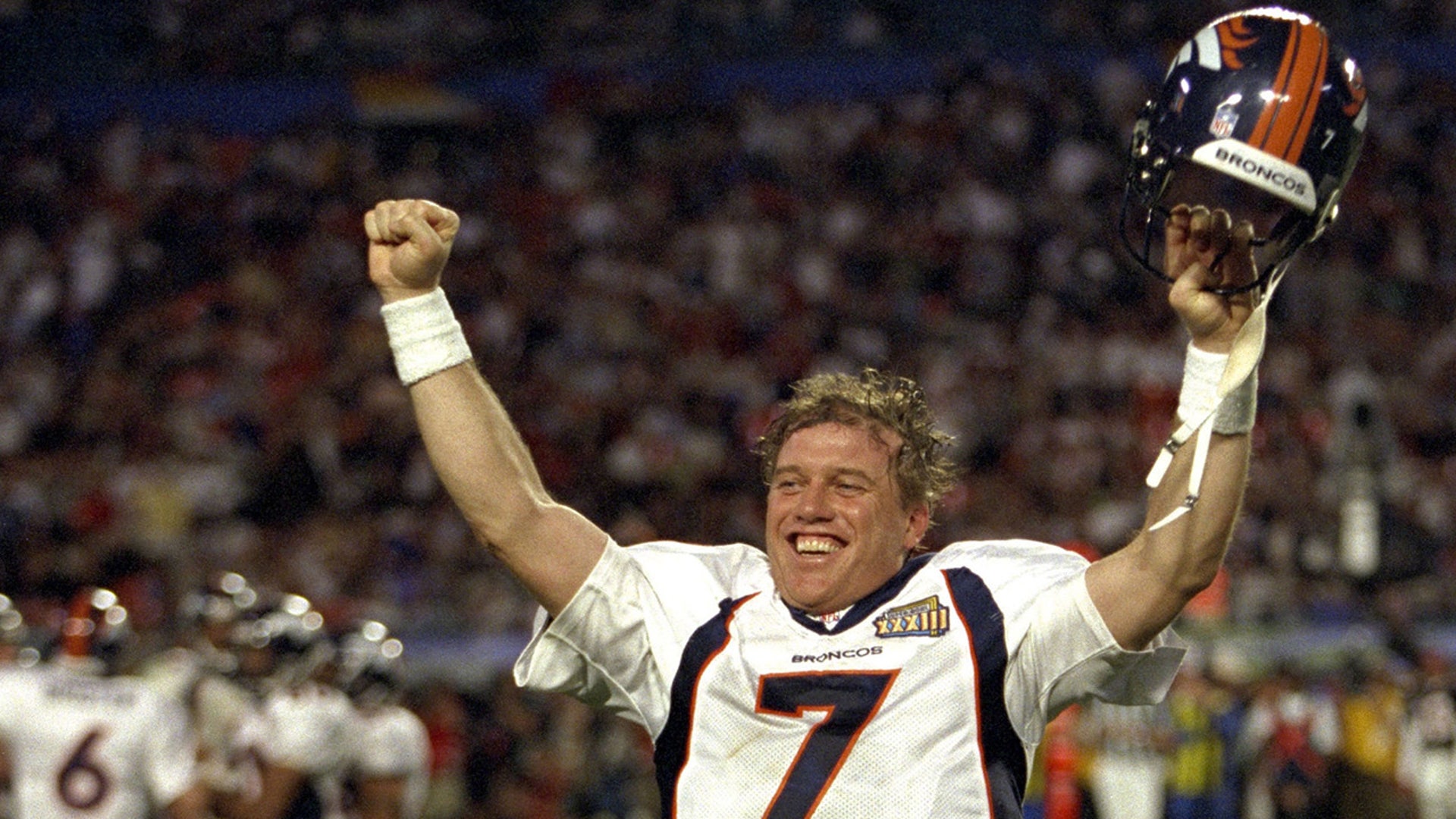 Jan. 31, 1999, Miami: Quarterback John Elway #7 raises his hands in victory after he is pulled from the game in the final seconds of the Denver Broncos Super Bowl XXXIII victory over the Atlanta Falcons 34-19 at Pro Player Stadium. This would be John Elway's last football game of his career.