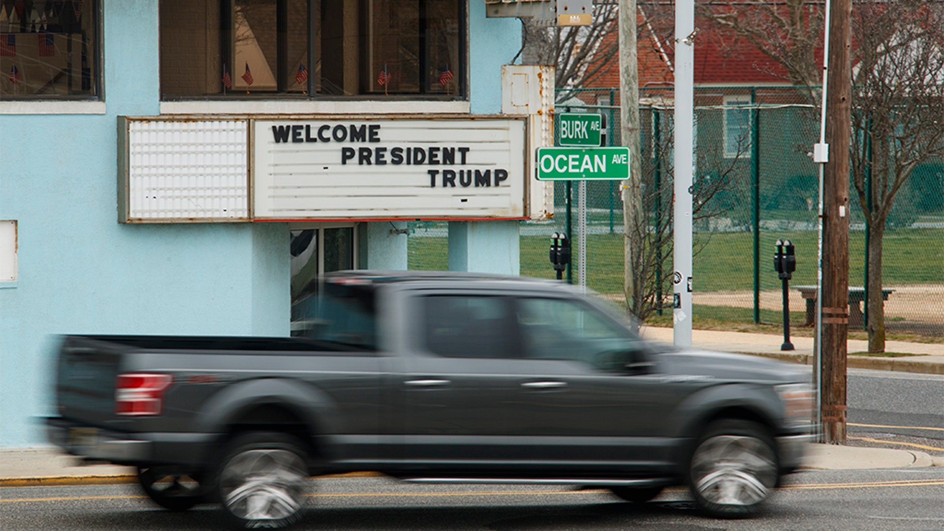 A pickup truck passing a sign welcoming President Trump in Wildwood, N.J.