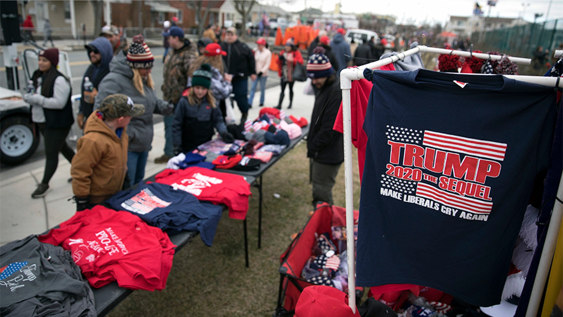 People walking past vendors selling Trump merchandise near the Wildwoods Convention Center before the campaign rally.