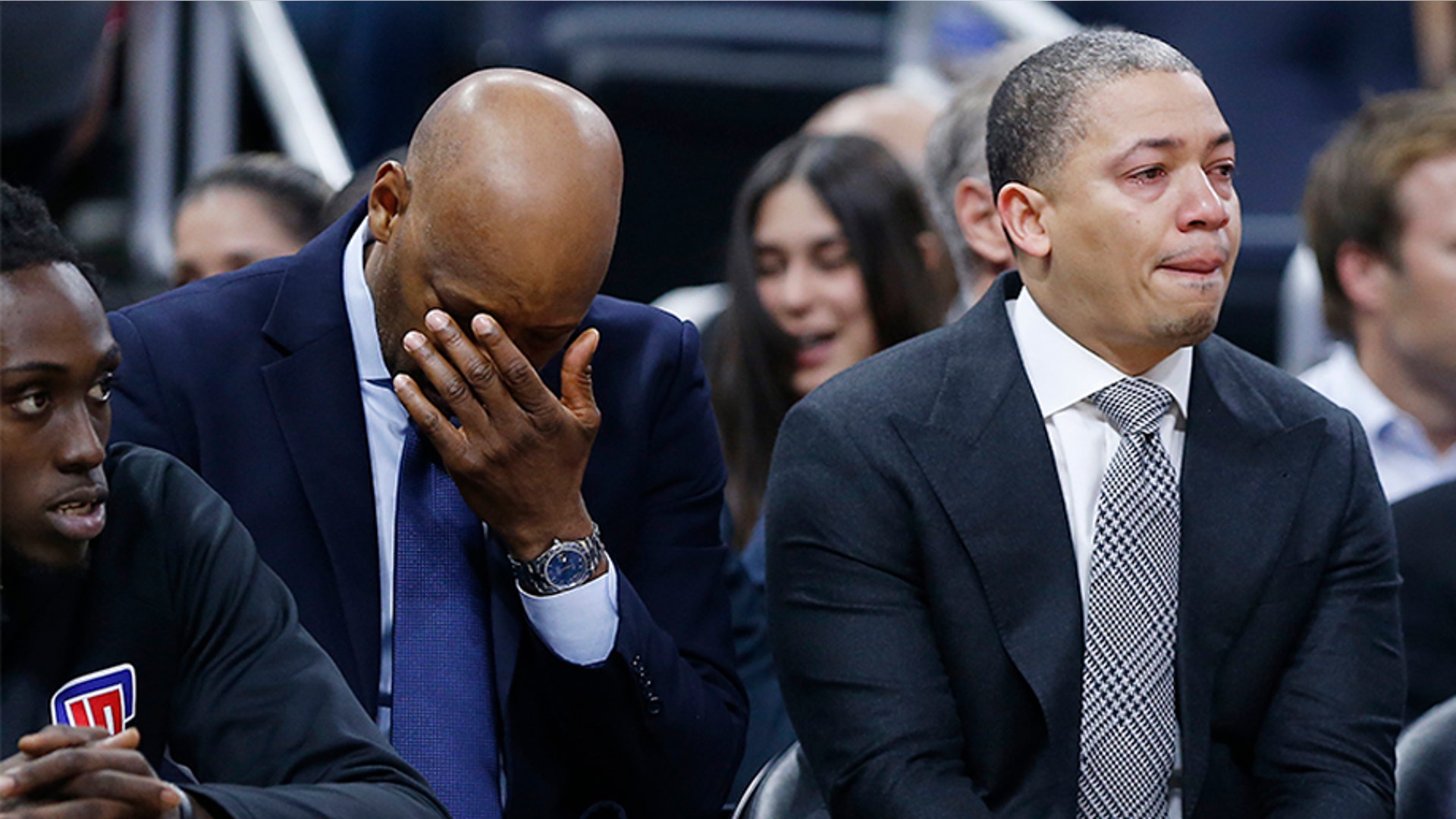 Assistant coach Sam Cassell and Tyronn Lue of the LA Clippers react on the bench after honoring Bryant.