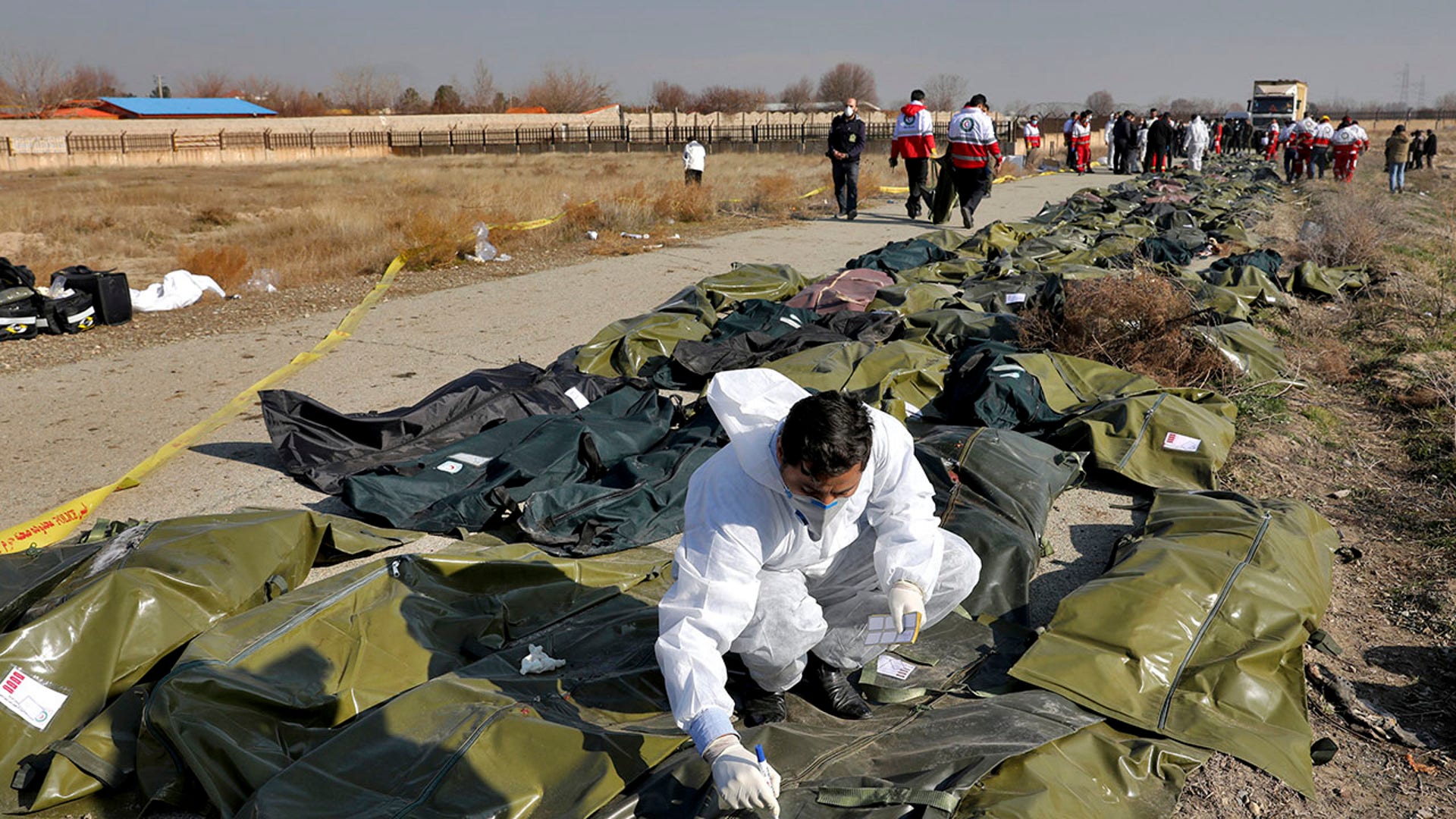 A forensic investigator works at the scene as bodies of the victims are collected, in Shahedshahr, southwest of the capital Tehran. 