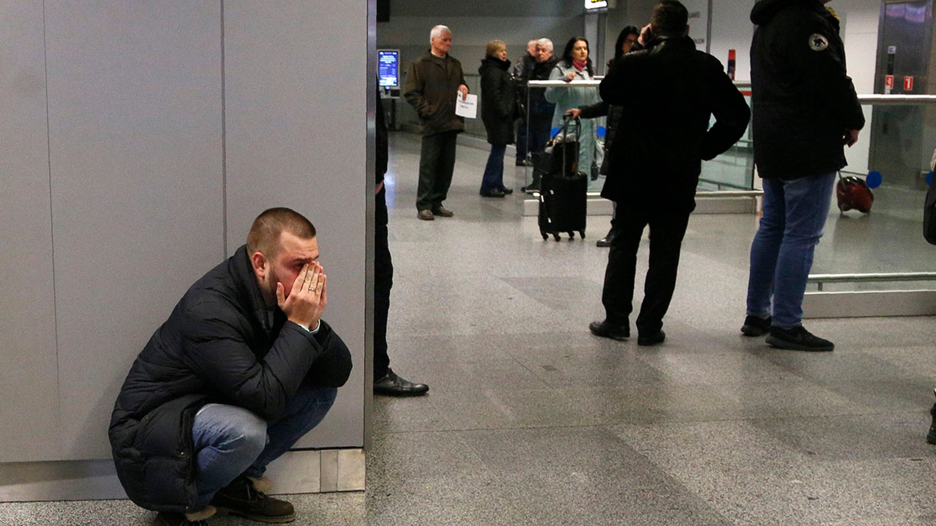 A relative of a flight attendant on the Ukrainian 737-800 plane that crashed on the outskirts of Tehran, reacts at Borispil international airport outside Kiev. (AP Photo/Efrem Lukatsky)