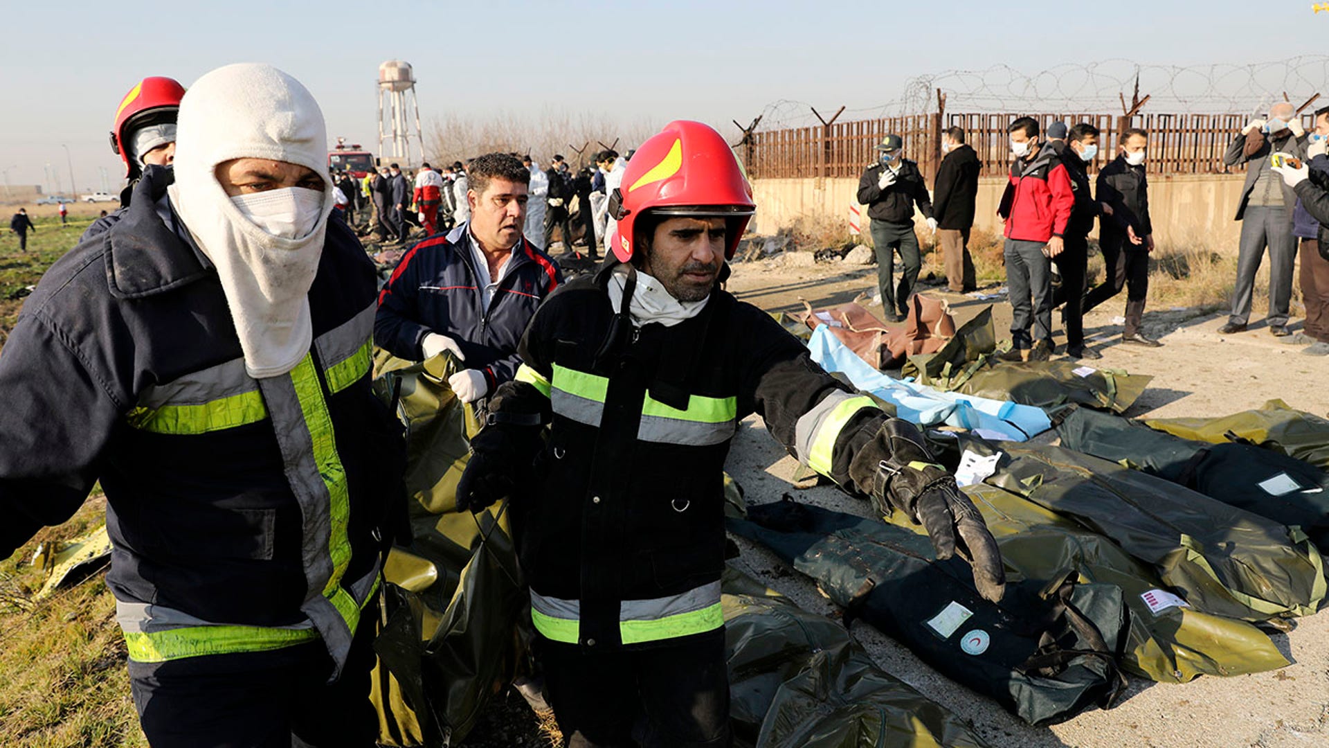 Rescue workers carry the body of a victim. 