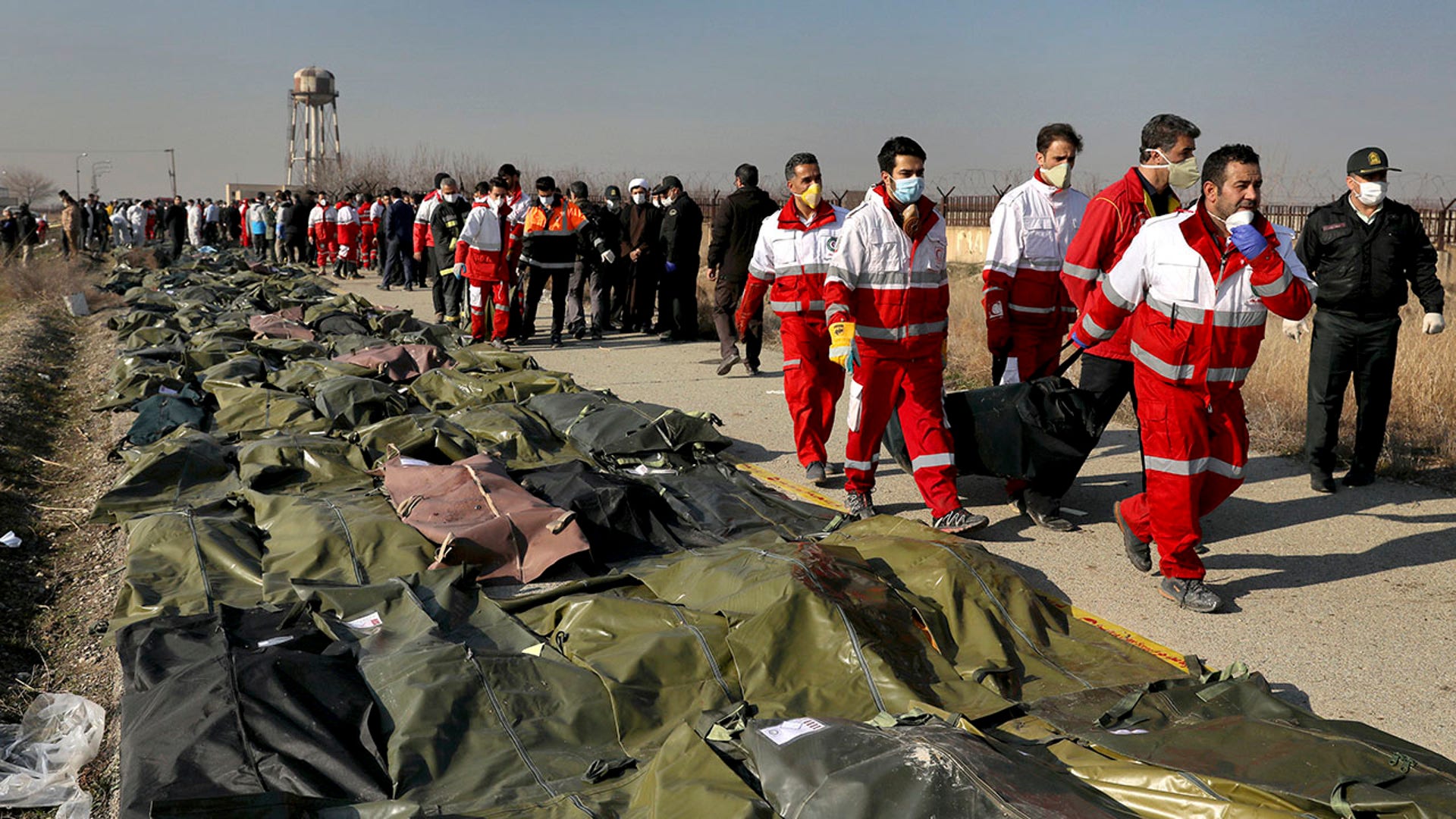 Rescue workers carry the body of a victim of a Ukrainian plane crash near Tehran, Iran. 