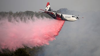 Australian wildfire sparked by helicopter fighting blazes threatens homes on Canberra outskirts
