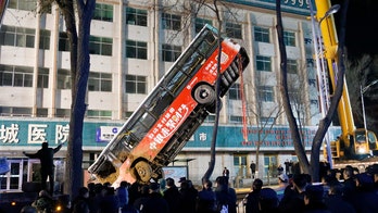 China sinkhole swallows bus, leaves at least 6 dead, several missing