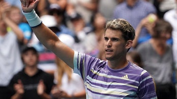 Amid rain and red hue, Medvedev, Thiem advance in Australia