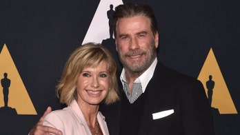 John Travolta on reuniting with Olivia Newton-John: 'We love each other'