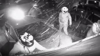 Gang of motorcycle thieves rip door off garage to steal bike as security camera rolls