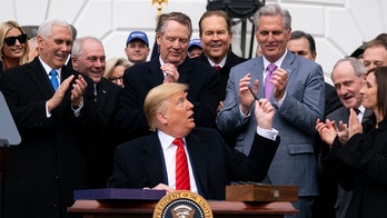 Trump appears to mock Pelosi by handing out pens during USMCA signing
