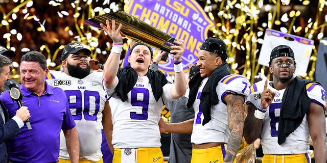 NEW ORLEANS, LOUISIANA - JANUARY 13: Joe Burrow of the LSU Tigers raises the National Championship Trophy with Ed Orgeron, Grant Delpit #7, Patrick Queen #8, and Rashard Lawrence #90 after the College Football Playoff National Championship game at the Mercedes Benz Superdome on January 13, 2020 in New Orleans, Louisiana. The LSU Tigers <a data-cke-saved-href="https://www.foxnews.com/sports" href="https://www.foxnews.com/sports" target="_blank">https://www.foxnews.com/sports</a>topped the Clemson Tigers, 42-25. (Photo by Alika Jenner/Getty Images)