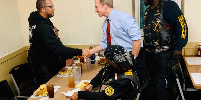 Tom Steyer chats with members of the Buffalo Soldiers bike gang at the Thunderbird Inn Buffet in Florence, S.C., Jan. 19.