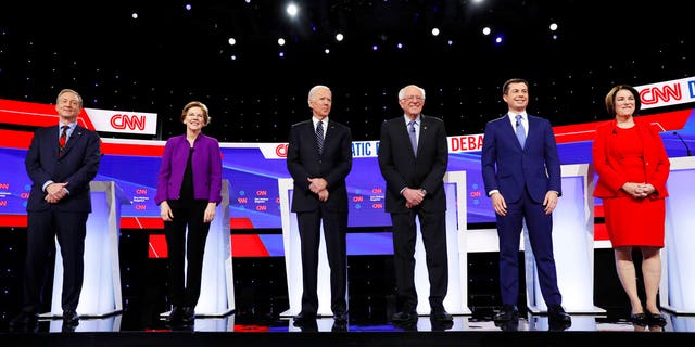 From left, Democratic presidential candidates businessman Tom Steyer, Sen. Elizabeth Warren, D-Mass., former Vice President Joe Biden, Sen. Bernie Sanders, I-Vt., former South Bend Mayor Pete Buttigieg, and Sen. Amy Klobuchar, D-Minn., stand on stage, Tuesday, Jan. 14, 2020, before a Democratic presidential primary debate hosted by CNN and the Des Moines Register in Des Moines, Iowa. (AP Photo/Charlie Neibergall)