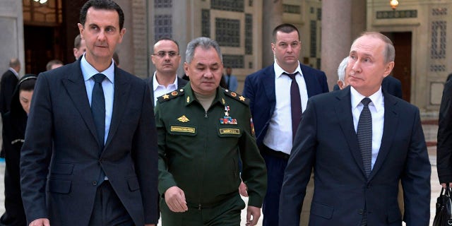 Russian President Vladimir Putin, right, Syrian President Bashar Assad, left, and Russian Defense Minister Sergei Shoigu, center, visit the Umayyad Mosque in Damascus, Syria, Tuesday, Jan. 7, 2020. Putin has traveled to Syria to meet with President Bashar Assad, a key Iranian ally. The rare visit Tuesday comes amid soaring tensions between Iran and the United States following the U.S. drone strike last week that killed a top Iranian general who led forces supporting Assad in Syria's civil war. (Alexei Nikolsky/Sputnik, Kremlin Pool Photo via AP)