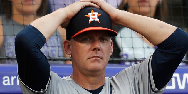 FILE - In this July 2, 2019, file photo, Houston Astros manager AJ Hinch reacts during a baseball game against the Colorado Rockies, in Denver. Houston manager AJ Hinch and general manager Jeff Luhnow were suspended for the entire season Monday, Jan. 13, 2020, and the team was fined $5 million for sign-stealing by the team in 2017 and 2018 season. (AP Photo/David Zalubowski, File)