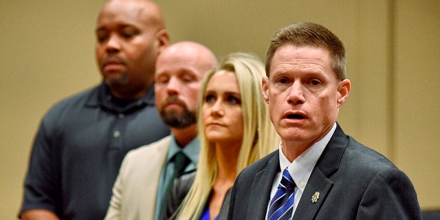 Dale County District Attorney Kirk Adams speaks about dropping murder charges against Carl Harris Jr. for the 1990 death of his wife during a news conference at Ozark City Hall, Ala., Monday, Jan. 13, 2020. Also shown are Jordan Davis, from right, Michael Bryant and Jimmy Culbreth. (Jay Hare/Dothan Eagle via AP)
