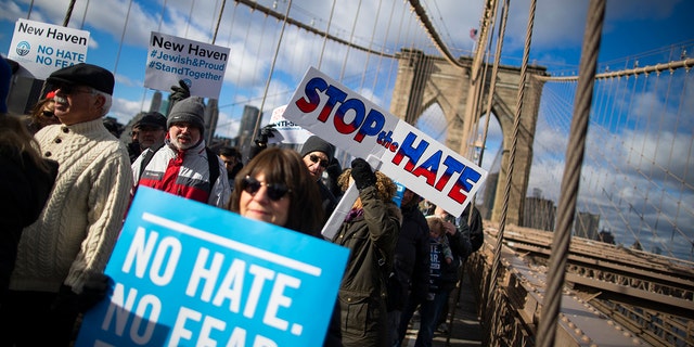 People take part in a march crossing the Brooklyn Bridge in solidarity with the Jewish community after a string of antisemitic attacks throughout the greater New York area, on Sunday, Jan. 5, 2020 in New York.  (AP Photo/Eduardo Munoz Alvarez)