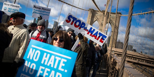 People take part in a march crossing the Brooklyn Bridge in solidarity with the Jewish community after a string of antisemitic attacks throughout the greater New York area, on Sunday, Jan. 5, 2020 in New York.  (AP Photo/Eduardo Munoz Alvarez)