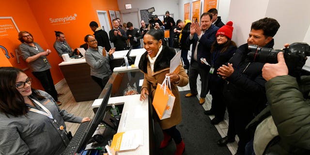 Illinois Lt. Gov. Juliana Stratton reacts after purchasing recreational marijuana at Sunnyside dispensary Wednesday, Jan. 1, 2020, in Chicago. (AP Photo/Paul Beaty)