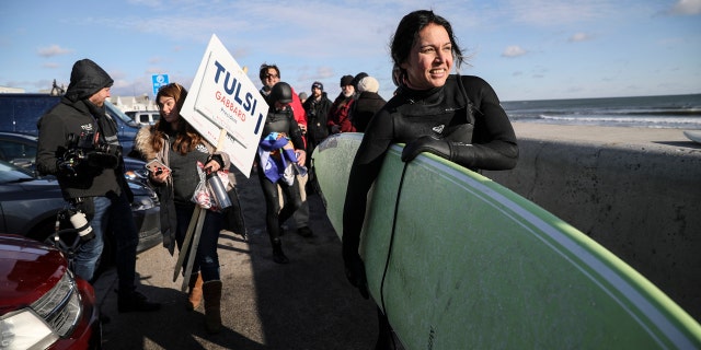 Tulsi Gabbard surfs in frigid New Hampshire waters to ring in new year 1 Democratic presidential candidate U.S. Rep. Tulsi Gabbard, D-Hawaii, carries her surfboard after surfing the Atlantic Ocean, Wednesday, Jan. 1, 2020, in Hampton, N.H. (AP Photo/Cheryl Senter)