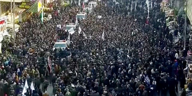 In this image made from a video, mourners gather for a funeral procession for Gen. Qassem Soleimani, in Baghdad Saturday, Jan. 4, 2020. (PMF Media Office via AP)