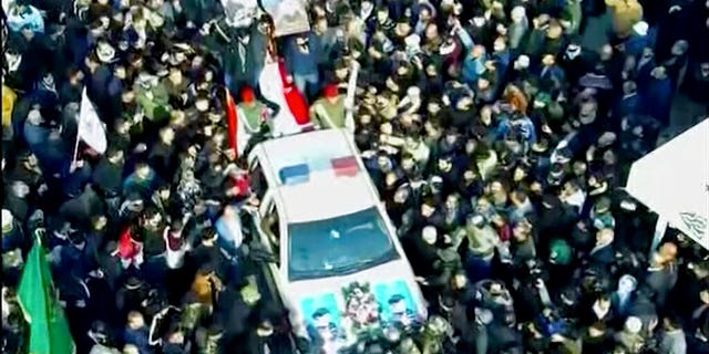 In this image made from a video, mourners gather for a funeral procession for Gen. Qassem Soleimani, in Baghdad Saturday, Jan. 4, 2020. The head of Iran's elite Quds force and mastermind of its regional security strategy, was killed in an airstrike early Friday near the Iraqi capital's international airport that has caused regional tensions to soar. 