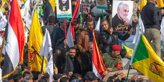 People attend the funeral of Iran's top general Qassem Soleimani and 9 Iranians and Iraqis, in Baghdad, Iraq, Saturday, Jan. 4, 2020. 