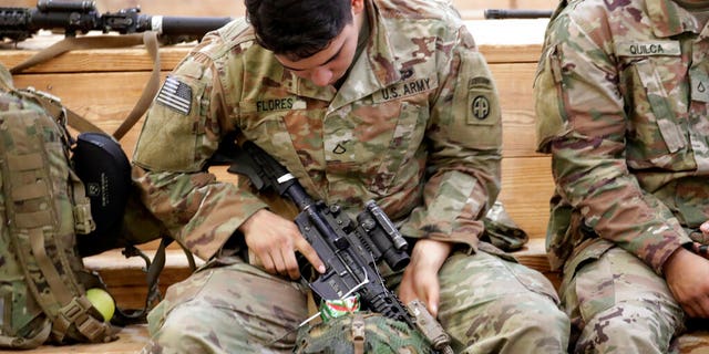 A U.S. Army soldier checking his rifle before heading out Saturday at Fort Bragg, N.C., as troops from the 82nd Airborne were deployed to the Middle East. (AP Photo/Chris Seward)