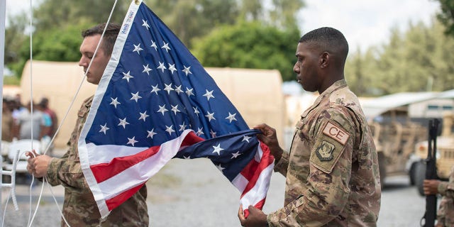 US Soldier Folding American Flag