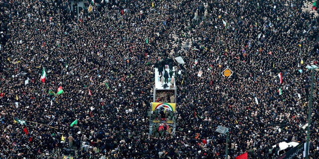 Coffins of Gen. Qassem Soleimani and others who were killed in Iraq by a U.S. drone strike, are carried on a truck surrounded by mourners during a funeral procession, in the city of Mashhad, Iran, Sunday, Jan. 5, 2020. (Mohammad Hossein Thaghi/Tasnim News Agency via AP)