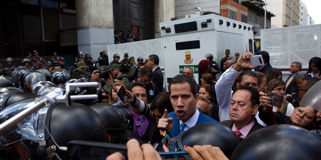 National Assembly President Juan Guaidó, Venezuela's opposition leader, arguing with police as he and other lawmakers were stopped a few blocks from the Assembly where he had been set to lead the session to elect new leadership in Caracas.