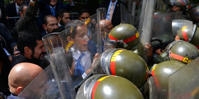 National Assembly President Juan Guaidó, Venezuela's opposition leader, was blocked by national guardsmen from entering the compound of the Assembly, where he was to lead a session to elect new leadership in Caracas.