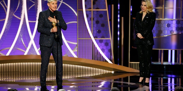 This image released by NBC shows Ellen DeGeneres accepts the Carol Burnett TV Achievement Award as presenter Kate McKinnon, right, looks on at the 77th Annual Golden Globe Awards.