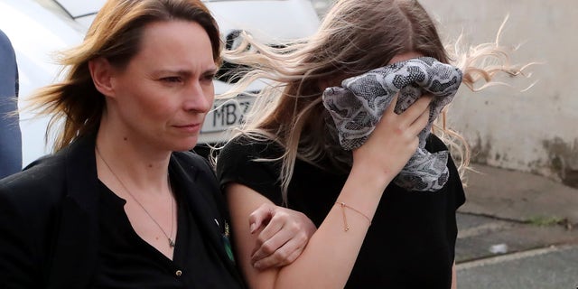 A 19-year-old British woman, right, that was found guilty of making up claims she was raped by up to 12 Israelis, arrives at Famagusta District Court with her mother for sentencing on Tuesday, Jan. 7, 2020. A Cyprus court handed a four-month suspended sentence to a 19-year-old British woman who was found guilty of public mischief for making up claims that she was raped by up to a dozen Israelis. (AP Photo/Petros Karadjias)