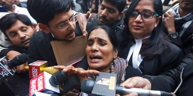 Asha Devi, mother of the victim of the fatal 2012 gang rape on a moving bus, speaks to the media as she leaves a court in New Delhi, India, Tuesday, Jan. 7, 2020. A