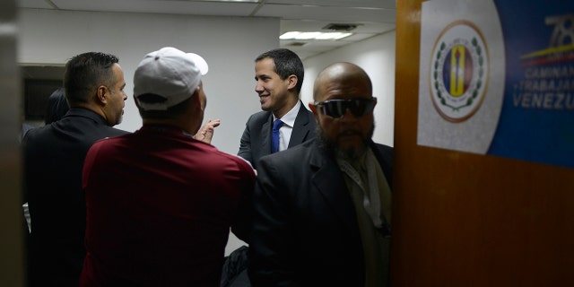 Opposition leader Juan Guaido arrives at the political headquarters of "Democratic Action" before going to the National Assembly in Caracas, Venezuela, Tuesday, Jan. 7, 2020. (AP Photo/Matias Delacroix)