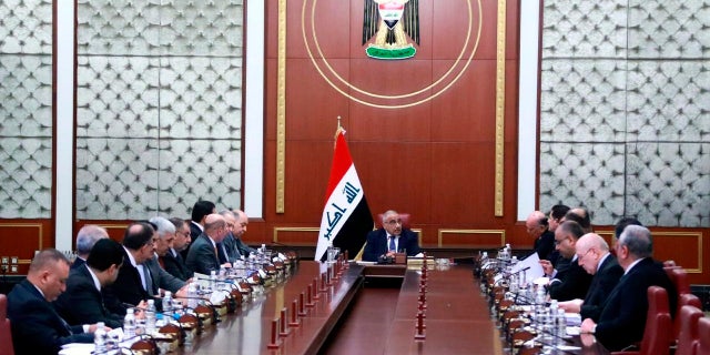 In a photo released by the Iraqi Prime Minister Media Office, Prime Minister Adil Abdul-Mahdi, center, heads a cabinet meeting at the prime minister's office, in Baghdad, Iraq, on Tuesday. Abdul-Mahdi called for American troops to leave the country amid escalating tensions between the U.S. and Iran. (Iraqi Prime Minister Media Office, via AP)