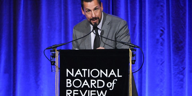 Adam Sandler accepts the best actor award for 