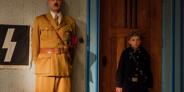 This image released by Fox Searchlight Pictures shows Taika Waititi, left, and Roman Griffin Davis in a scene from 