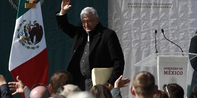 Mexico's President Andres Manuel Lopez Obrador waves to residents during his visit to the small town of La Mora, Sonora state, Mexico. Lopez Obrador said Sunday there is an agreement to establish a monument will be put up to memorialize nine U.S.-Mexican dual citizens ambushed and slain last year by drug gang assassins along a remote road near New Mexico. (AP Photo/Christian Chavez)