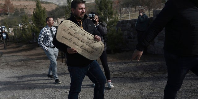 Lenzo Widmar carries a sign that reads in Spanish: "Without just punishment for crime, freed is without defense" at the small town of La Mora, Sonora state, Mexico last week. (AP Photo/Christian Chavez)