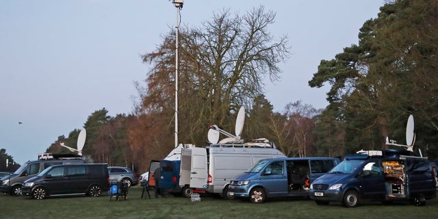 Media prepares in the early morning at the entrance of the castle in Sandringham, England, Monday, Jan. 13, 2020.