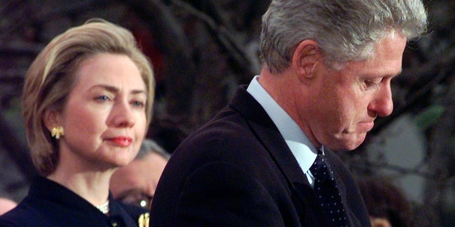 In this Dec. 19, 1998 file photo, first lady Hillary Rodham Clinton watches President Clinton pause as he thanks those Democratic members of the House of Representatives who voted against impeachment at the White House in Washington. 