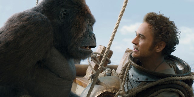 This image released by Universal Pictures shows Chee-Chee, voiced by Rami Malek, left, and Dr. John Dolittle, portrayed by Robert Downey Jr. in a scene from "Dolittle."