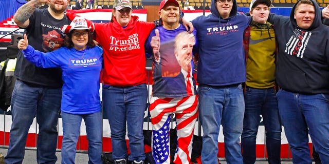 A group takes a picture in the front row as they arrive for a campaign rally with President Donald Trump Tuesday, Jan. 14, 2020, in Milwaukee. (AP Photo/Jeffrey Phelps)