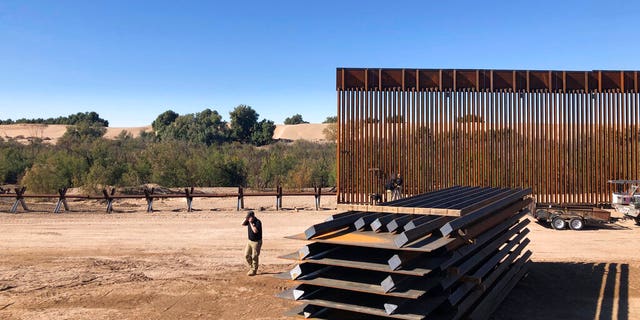 Crews working at a portion of border wall under construction in Yuma, Ariz.