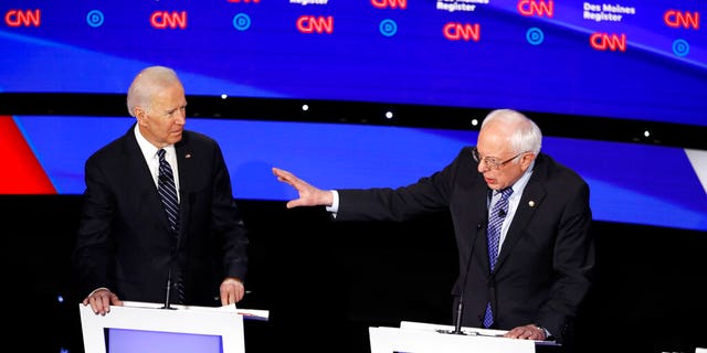 Democratic presidential candidate former Vice President Joe Biden, left, watches as Sen. Bernie Sanders, I-Vt., answers a question Tuesday, Jan. 14, 2020, during a Democratic presidential primary debate hosted by CNN and the Des Moines Register in Des Moines, Iowa. (AP Photo/Patrick Semansky)