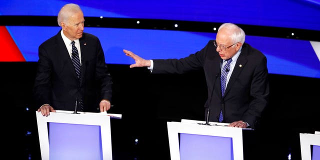 Democratic presidential candidate former Vice President Joe Biden, left, watches as Sen. Bernie Sanders, I-Vt., answers a question Tuesday, Jan. 14, 2020, during a Democratic presidential primary debate hosted by CNN and the Des Moines Register in Des Moines, Iowa. (AP Photo/Patrick Semansky)