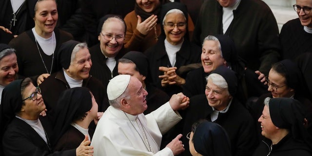 Pope Francis greets a group of nuns during his weekly general audience, in Paul VI Hall at the Vatican on Wednesday. (AP Photo/Alessandra Tarantino)